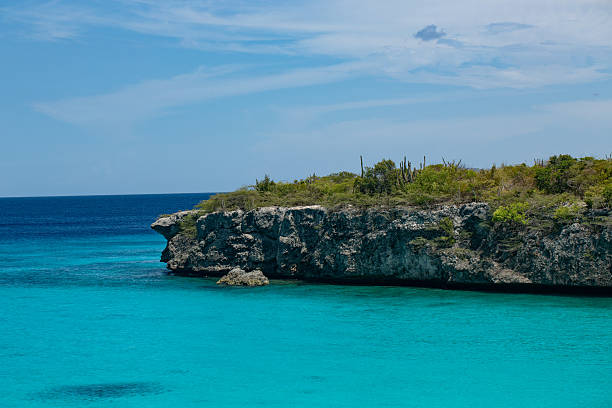 a colorful impression of the island's rough rocky coastline with the surrounding blue sea