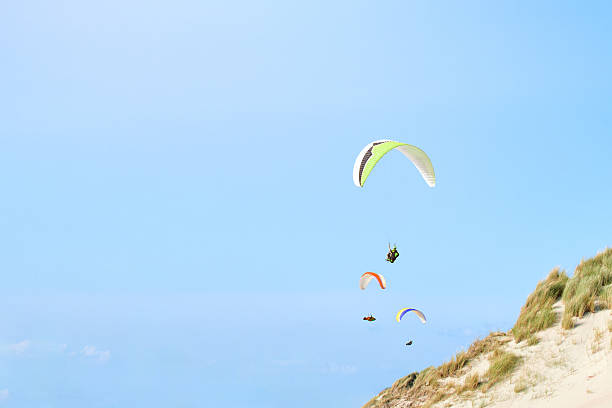 istock Colorful Paragliders Flying Above Dunes in Netherlands 2235616826