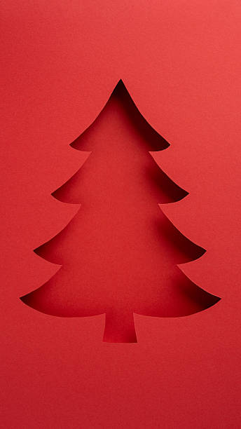 istock Festive vertical tree silhouette on red paper background, perfect for holiday greetings or inspirations 2235616918