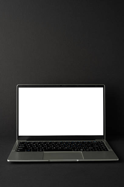 istock Open vertical laptop on a dark surface with a blank black screen, symbolizing technology and simplicity 2235616922