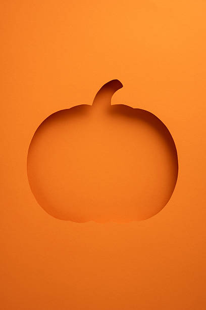istock A vertical creatively styled pumpkin cutout in an orange background, perfect for Halloween aesthetics and minimalistic decorations 2235616933