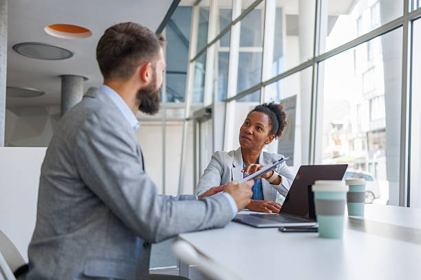 istock Business colleagues discussing a project in modern office 2235619616