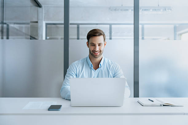 istock Middle-aged entrepreneur manager businessman using pc for communication, learning at workplace. European focused latin young business man working on laptop computer sitting at office workplace desk 2235620311