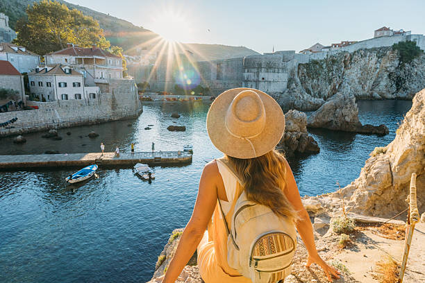 istock Woman Enjoying Sunny Coastal View with Hat 2235624475
