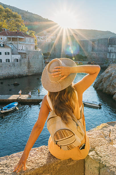 istock Woman Enjoying Sunny Coastal View with Hat 2235624592