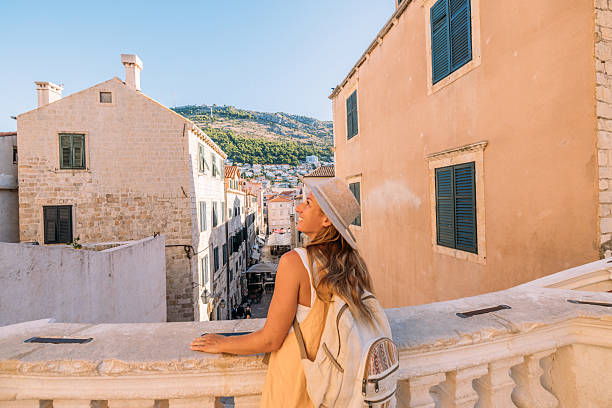 istock Woman Enjoying View from Historic Balcony 2235626425