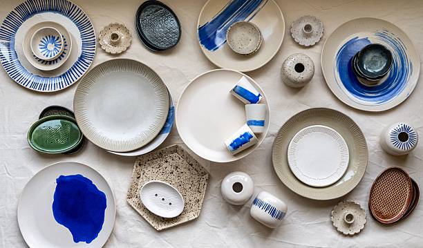 Assorted ceramic plates and bowls with blue accents.