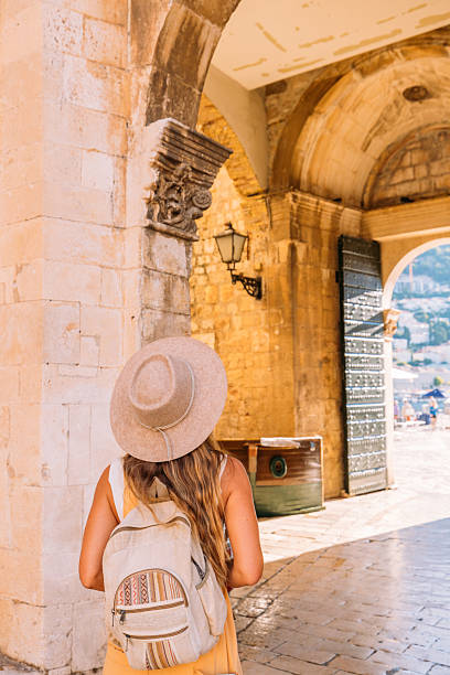 istock Woman Enjoying View Over Historic Archway 2235626772
