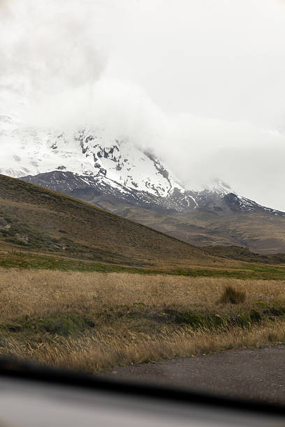 istock Misty mountain peak with snow and wide open grassland below 2235627443