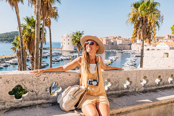 istock Woman Enjoying Sunny Harbor View in Summer 2235627647