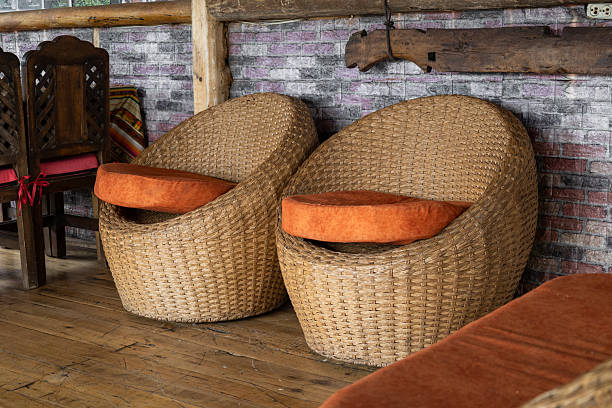 istock Wicker chairs with orange cushions 2235627780