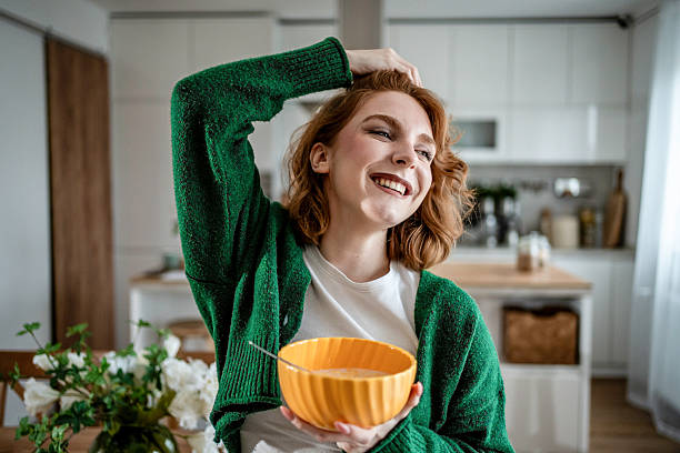 istock Happy redhead woman enjoying breakfast in kitchen 2235628212
