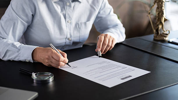 istock Lawyer signing an official document in the office 2235631253