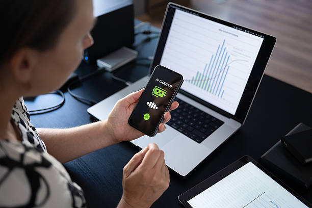 istock Woman using AI Chatbot on her smart phone while working in the office 2235631317