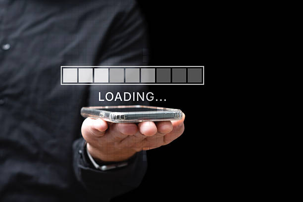 istock Man holding a smartphone with a digital loading bar and progress indicator overlay. Concept of internet connection, data transfer, mobile technology and digital transformation. 2235631606