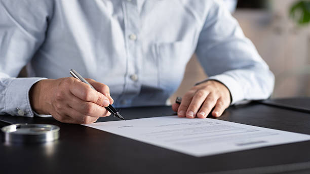 istock Lawyer signing an official document in the office 2235631753