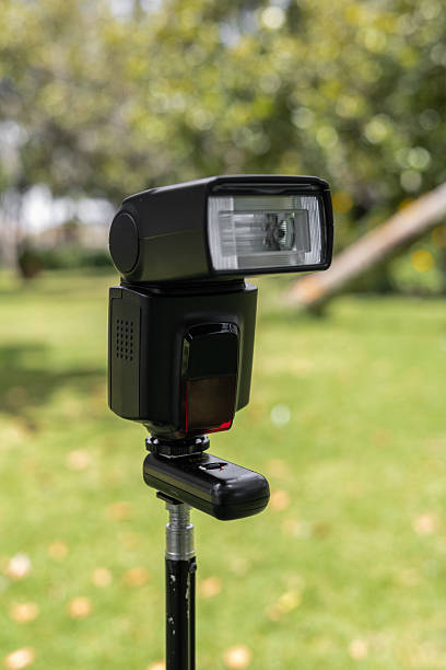 istock Professional camera flash on tripod outdoors 2235631769