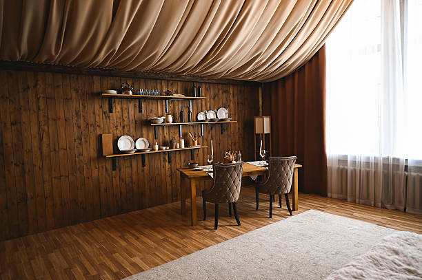 Cozy dining room with wooden walls and draped ceiling