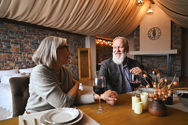 istock Senior couple enjoying romantic dinner with wine at home 2235632627