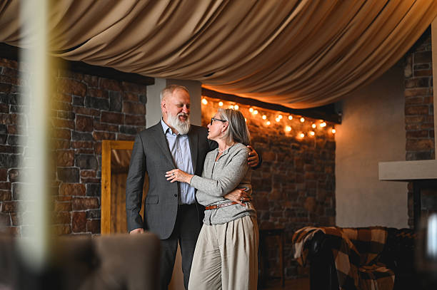 istock Senior couple embracing and smiling in elegant home interior 2235632758
