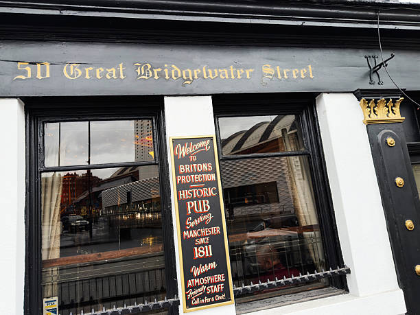 Manchester, UK - September 14, 2025: Historic pub with vibrant signage on Great Bridgewater Street in Manchester, UK. The Briton's Protection