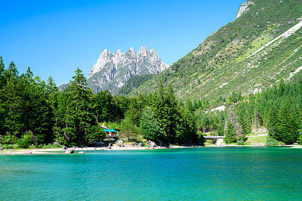 The beautiful blue green turquoise Predil lake in Italy, with mountains in background, close to the Slovenian border.