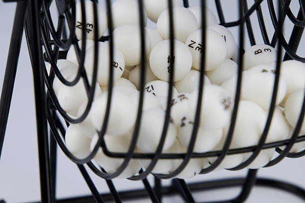 istock Bingo lottery balls in a dispenser container, foreground and white 2235638639