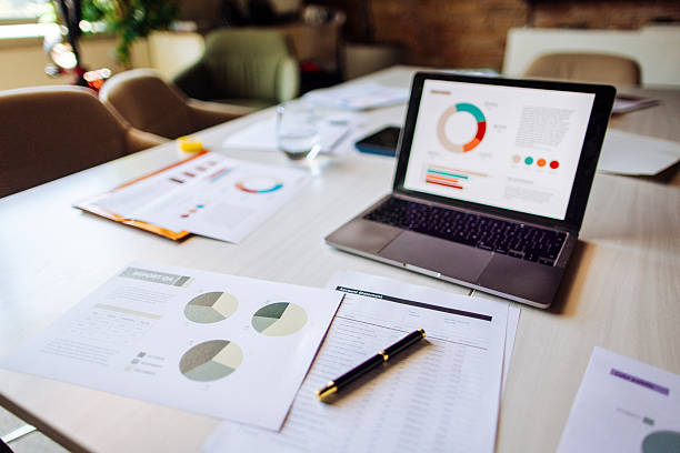 istock Analyzing Business Reports with Charts on a Desk Setup 2235638908