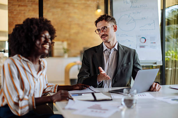 istock Collaborative Team Meeting with Lively Discussion and Financial Presentation 2235638928