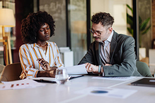 istock Business Team Collaborating on Report in a Modern Office Setting 2235638933