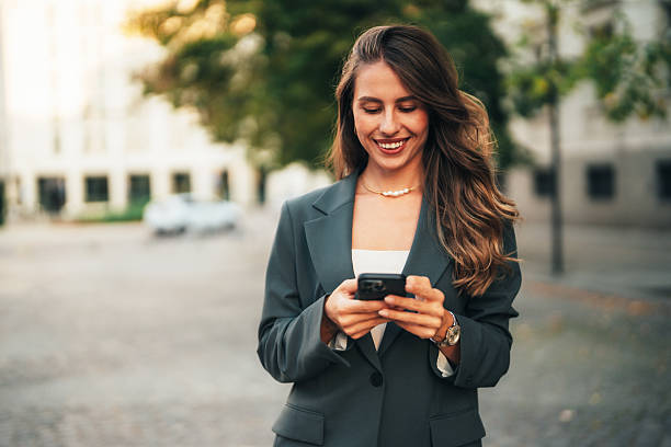 istock Elegant businesswoman using her phone 2235640119