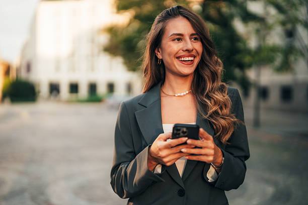 istock Elegant businesswoman using her phone 2235640121