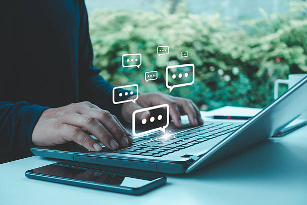 istock Businessman typing on laptop with chat icons, representing digital communication, online messaging, live chat, customer support, customer service, remote work in modern technology-driven environment 2235641114