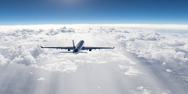istock Airplane Flying Above the Clouds During a Clear Sunny Day 2235643913