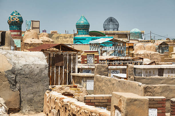 Graves in the historic Wadi us Salaam Cemetery in Najaf, Iraq, on a sunny day. It is the largest cemetery in the world.