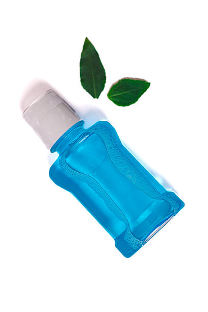 istock Mouthwash and green leaf 2235644388