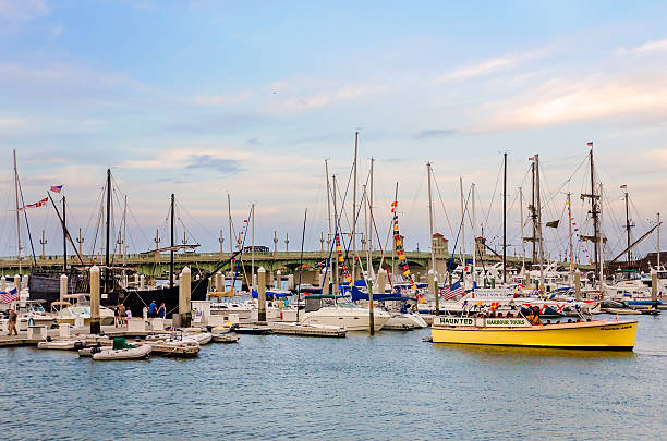 St. Augustine, Florida, USA - April 10, 2015: The Haunted Harbor Tours boat is docked with other boats at the St. Augustine Municipal Marina in St. Augustine, Florida.