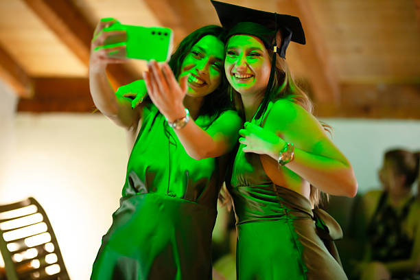 istock Two graduates celebrating and taking a selfie together with bright smiles 2235647811