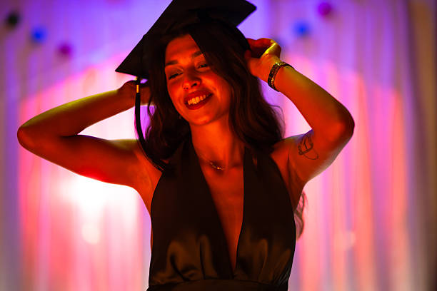 istock Smiling graduate posing with her cap on a vibrant celebration 2235647862