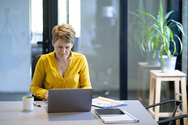 istock Businesswoman working on laptop in modern office 2235648201