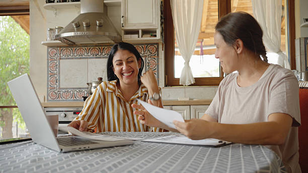 istock Financial Advisor Discussing With Happy Woman At Home 2235648256