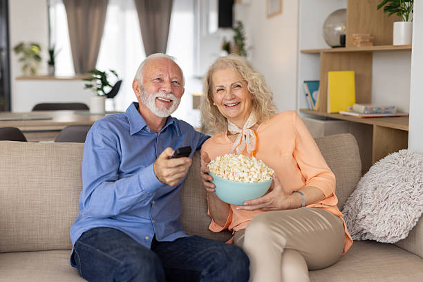 istock Elderly couple sharing a movie moment with popcorn 2235648891