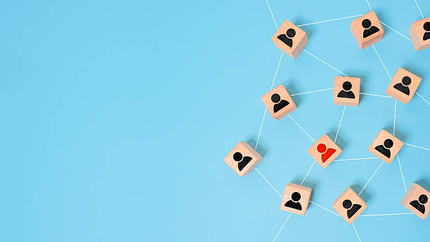 istock Organization structure, social network and teamwork concept on dark background. Business people icon on wooden cube blocks connecting network of connections 2235650089