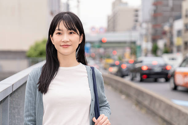 istock attractive asian woman going out 2235656363