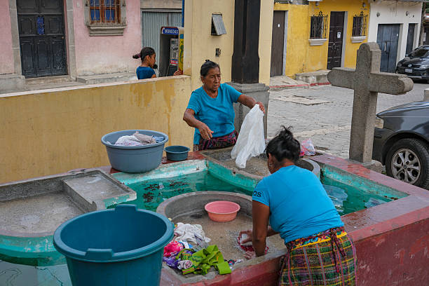 four indigenous friends playing games in the streets of Otavalo, Ecuador, throwing their facharinas into the air
