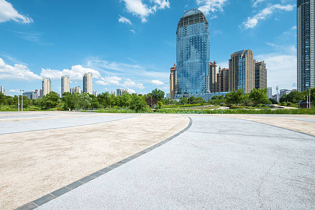 istock Empty square floor with modern urban skyline and sunny blue sky background 2235659350