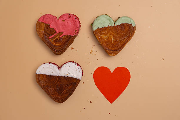 istock Creative ides Valentine's Day flat lay top view Holiday celebration Heart shaped different variety flavor croissants on beige background with copy space. Puff pastry new trendy sweet dessert bakery. Creamy dough 2235659544