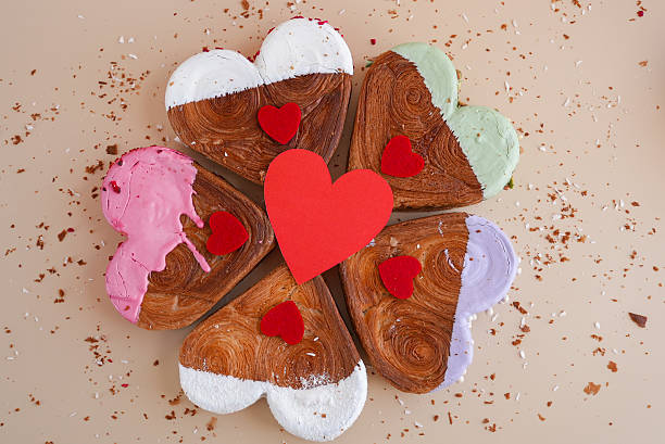 istock Valentine's Day flat lay top view Holiday celebration Heart shaped different variety flavor croissants on beige background with copy space. Puff pastry new trendy sweet dessert bakery. Creamy dough 2235660896