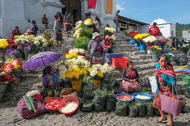 Chichicastenango, Guatemala - July 3, 2025: People selling flowers at the Santo Tomas Market in Chichicastenango, Guatemala.