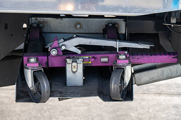 Close-up at locking device of safety latching strap that using for secure equipment or heavy object that transport on trailer truck. Transportation industrial equipment object, selective focus.